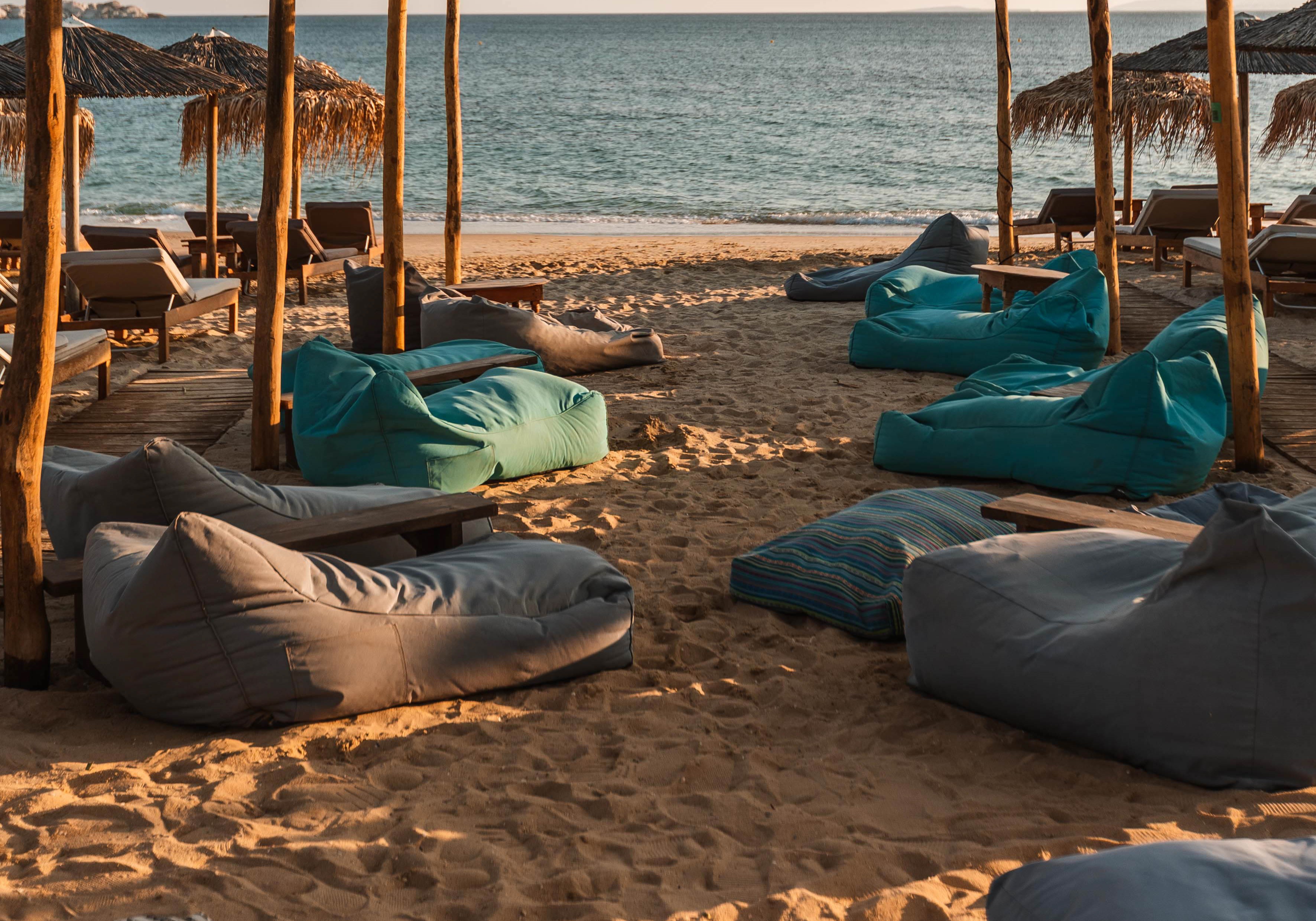 Turquoise bean bags facing the sea